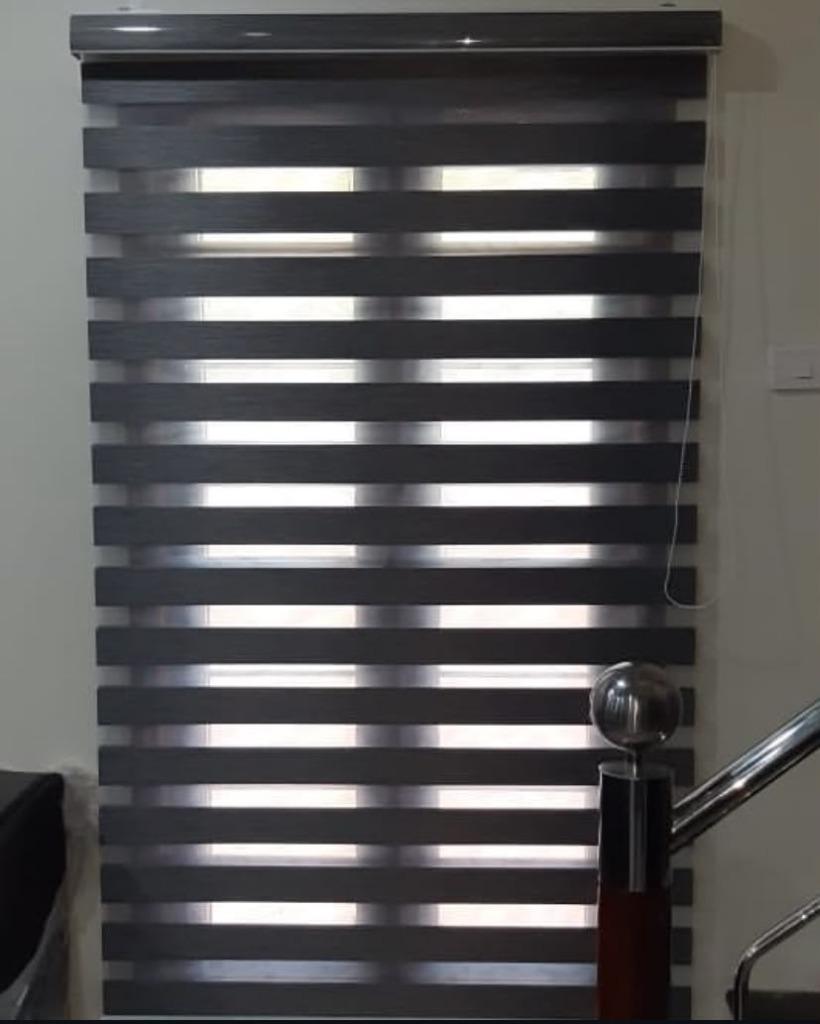 Grey zebra blinds installed on a staircase window