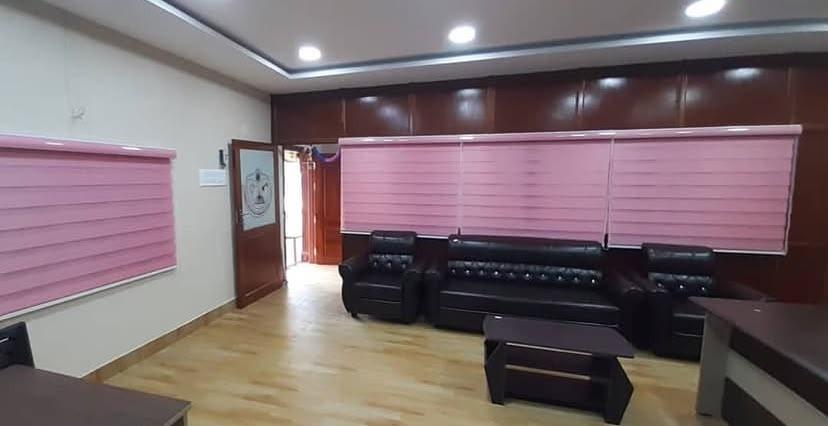 Pink zebra blinds wide view in corporate office room