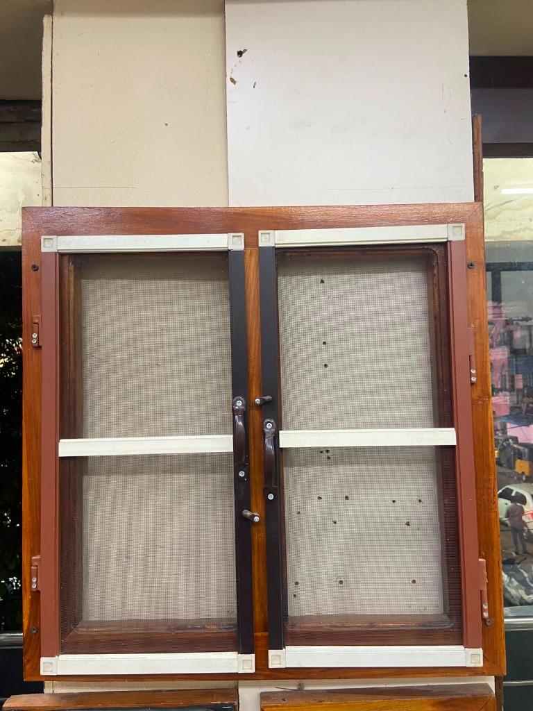 Sliding mosquito screens retrofitted on wood frame window